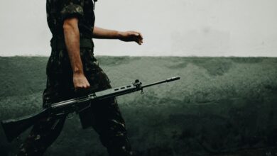 Armed military personnel in tactical gear during combat operations