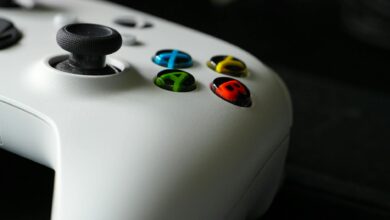 Black gaming controller on dark surface representing console gaming hardware