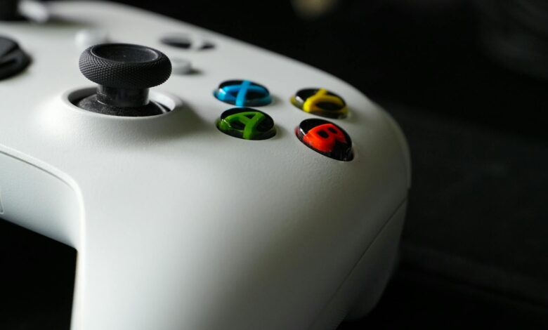 Black gaming controller on dark surface representing console gaming hardware