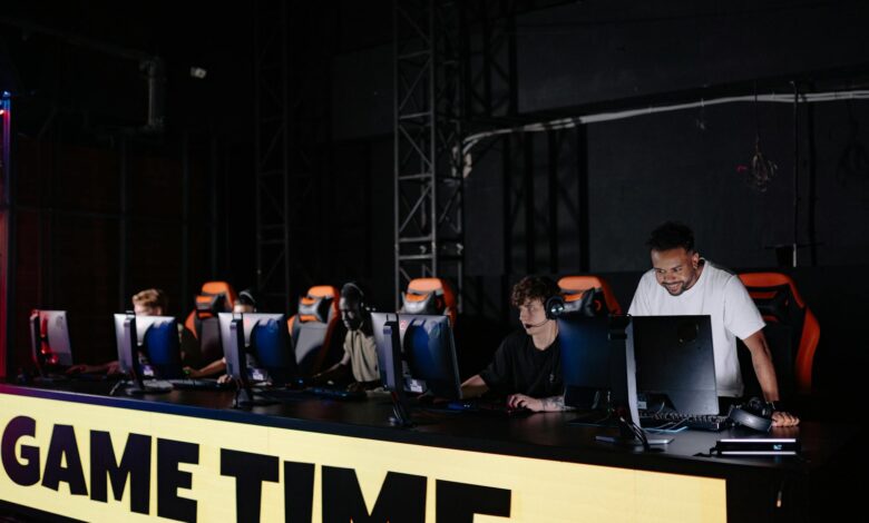 Professional esports tournament stage with large screens and competitive gaming setup