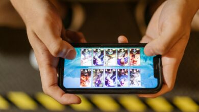 Person playing mobile game on smartphone with focused concentration