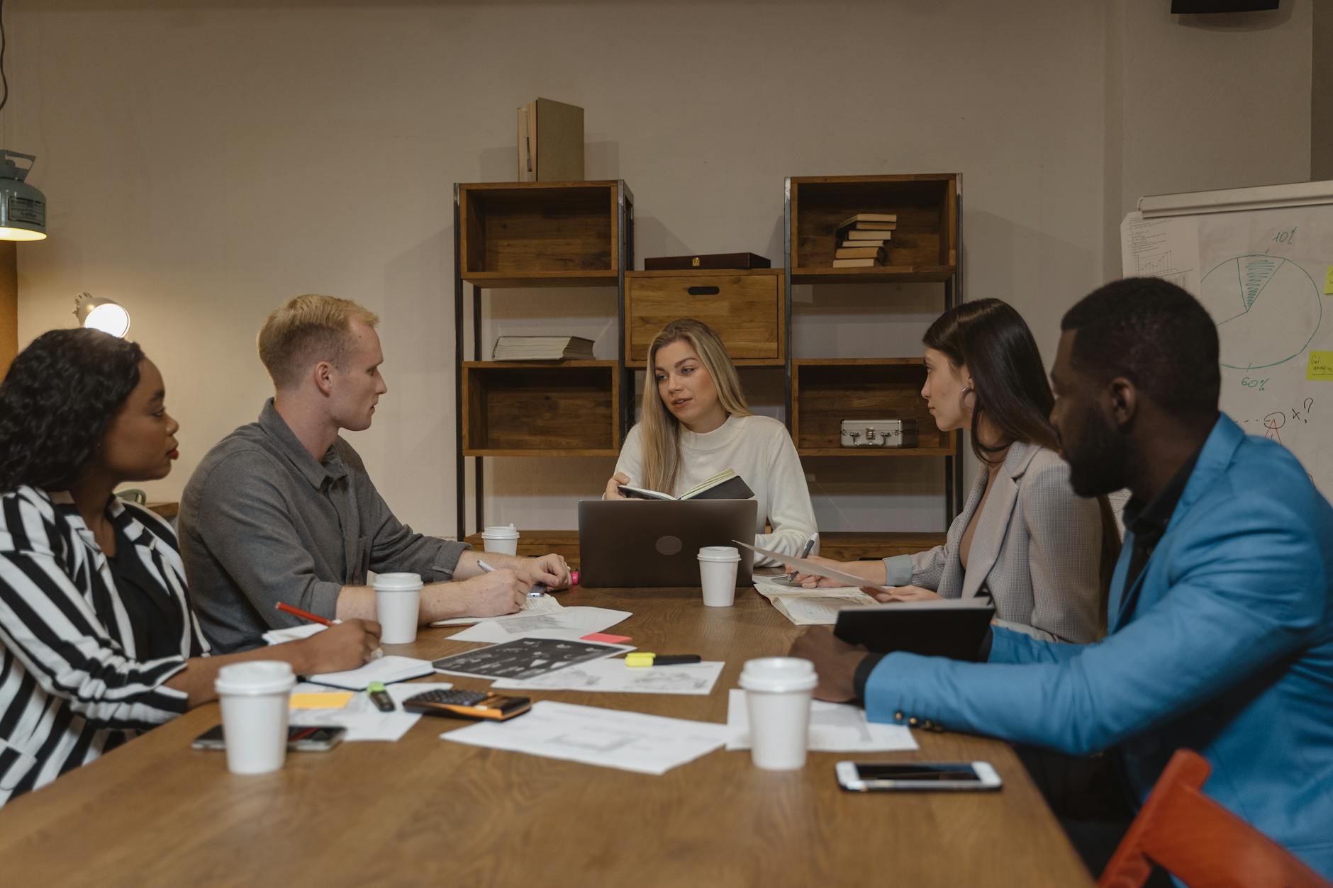 Business professionals discussing strategy in modern conference room