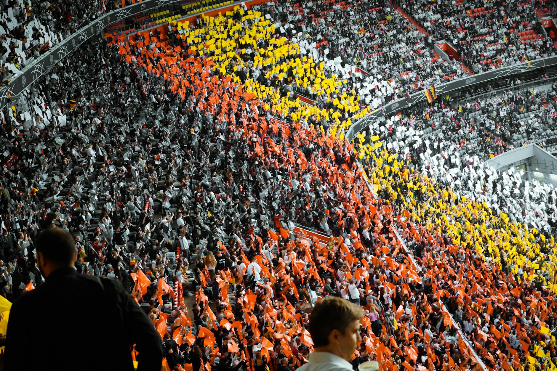 Packed college football stadium with enthusiastic crowd cheering during game