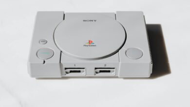 Modern gaming console on entertainment center with controller