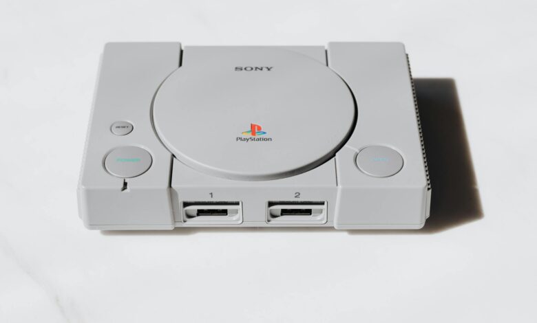 Modern gaming console on entertainment center with controller