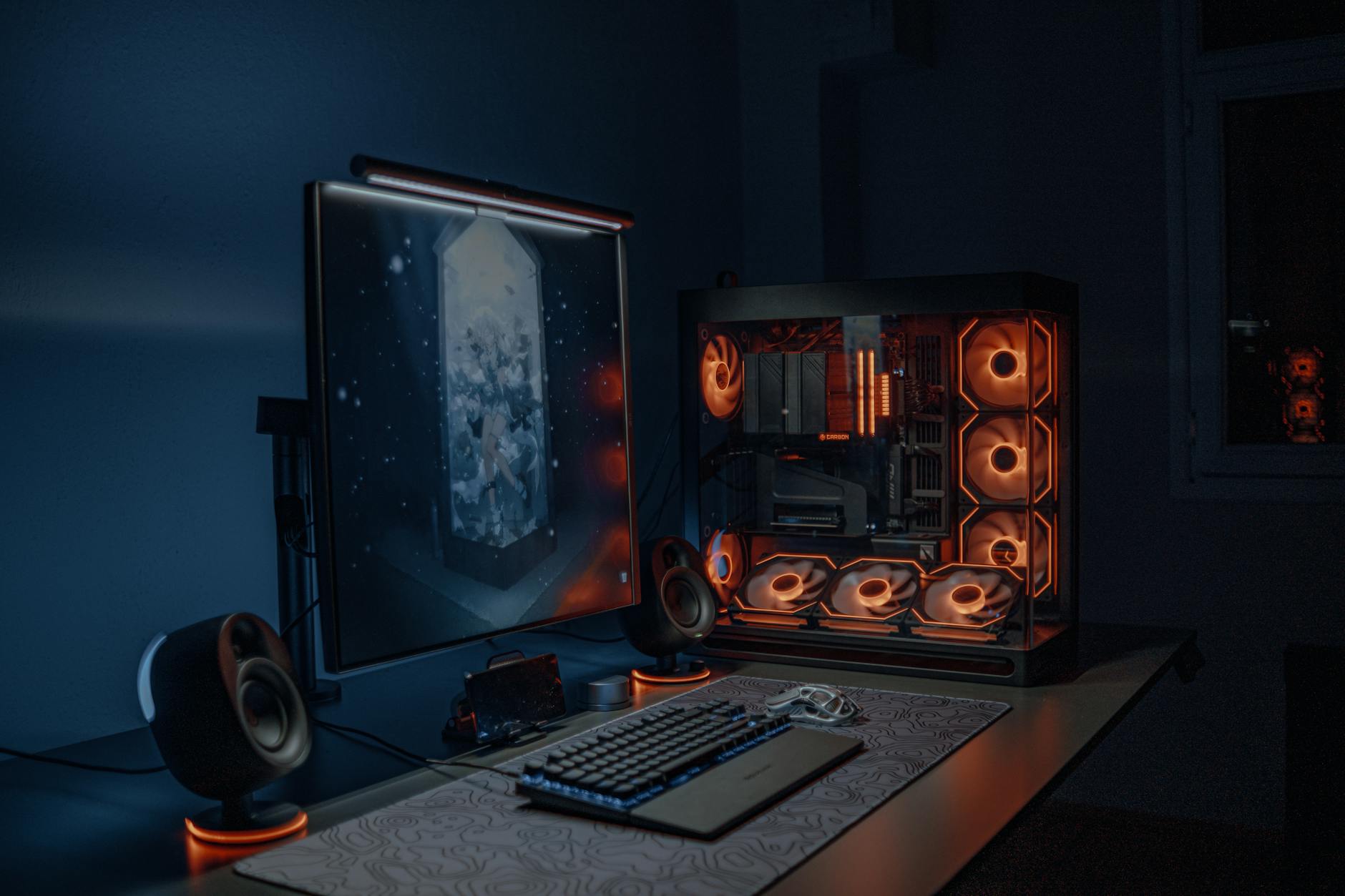 Gaming PC setup with multiple monitors displaying graphics settings menus