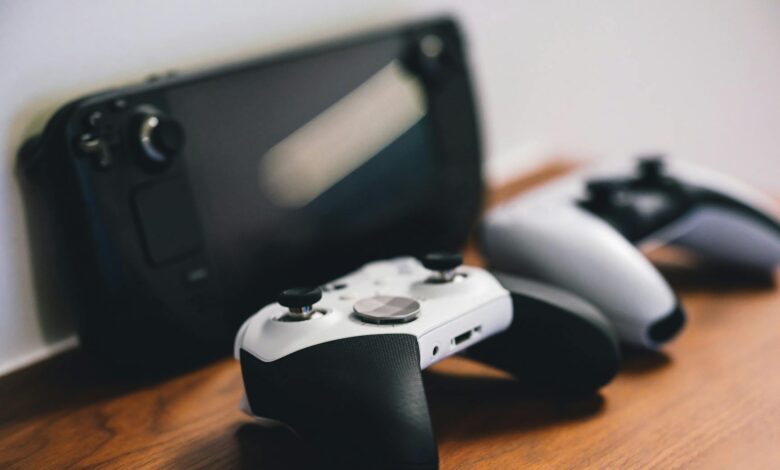 Modern gaming handheld device on wooden surface showing competitive portable gaming market