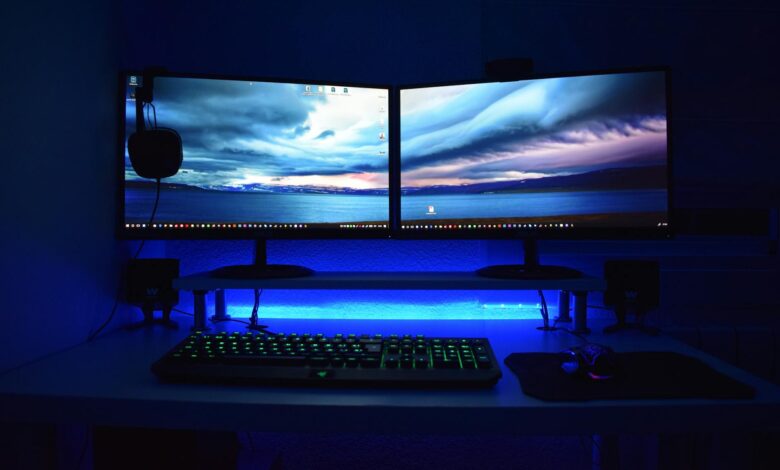 Modern gaming PC setup with monitor displaying performance metrics and RGB lighting