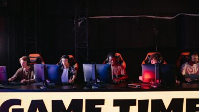 Large crowd watching esports tournament on big screens in arena setting