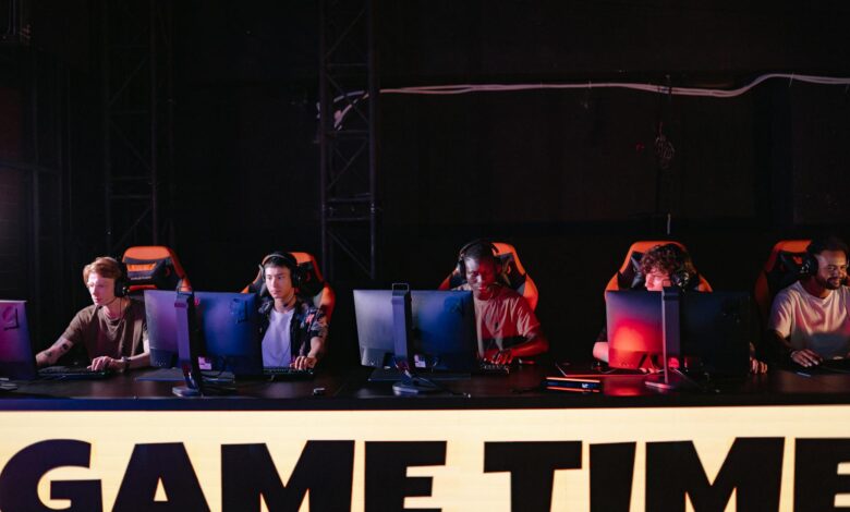 Large crowd watching esports tournament on big screens in arena setting