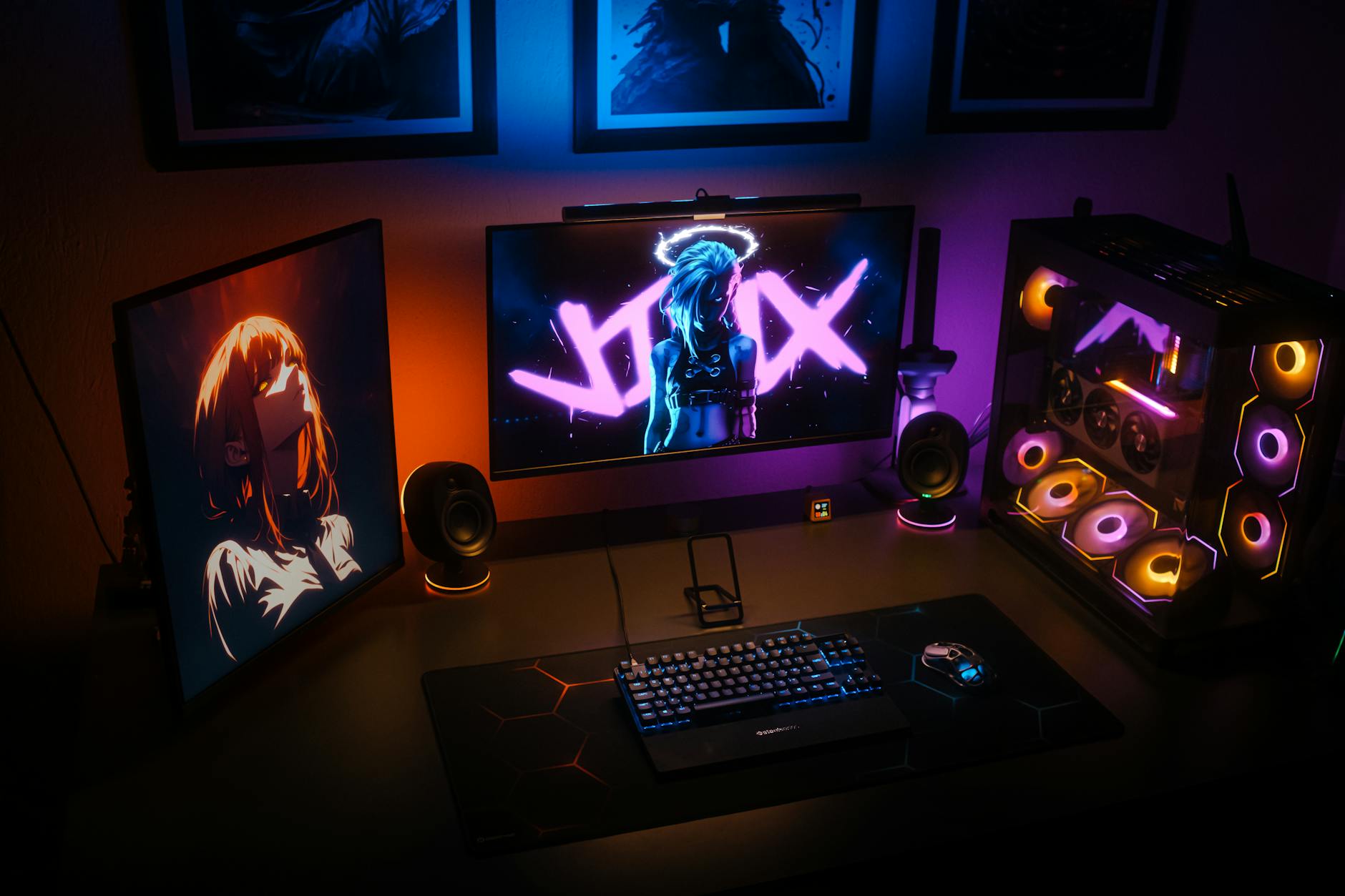 Gaming streaming setup with monitors, keyboard, and professional lighting equipment