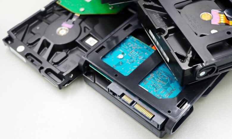 Various computer storage drives and components arranged on a desk