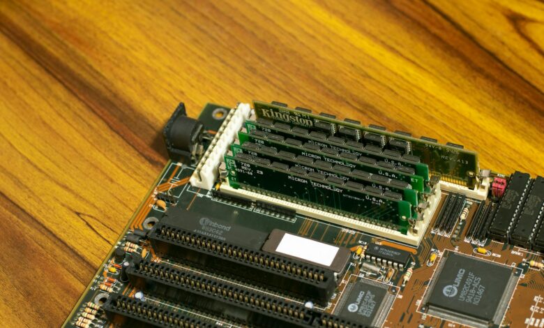 Various PC gaming components laid out including graphics card, motherboard, and RAM modules