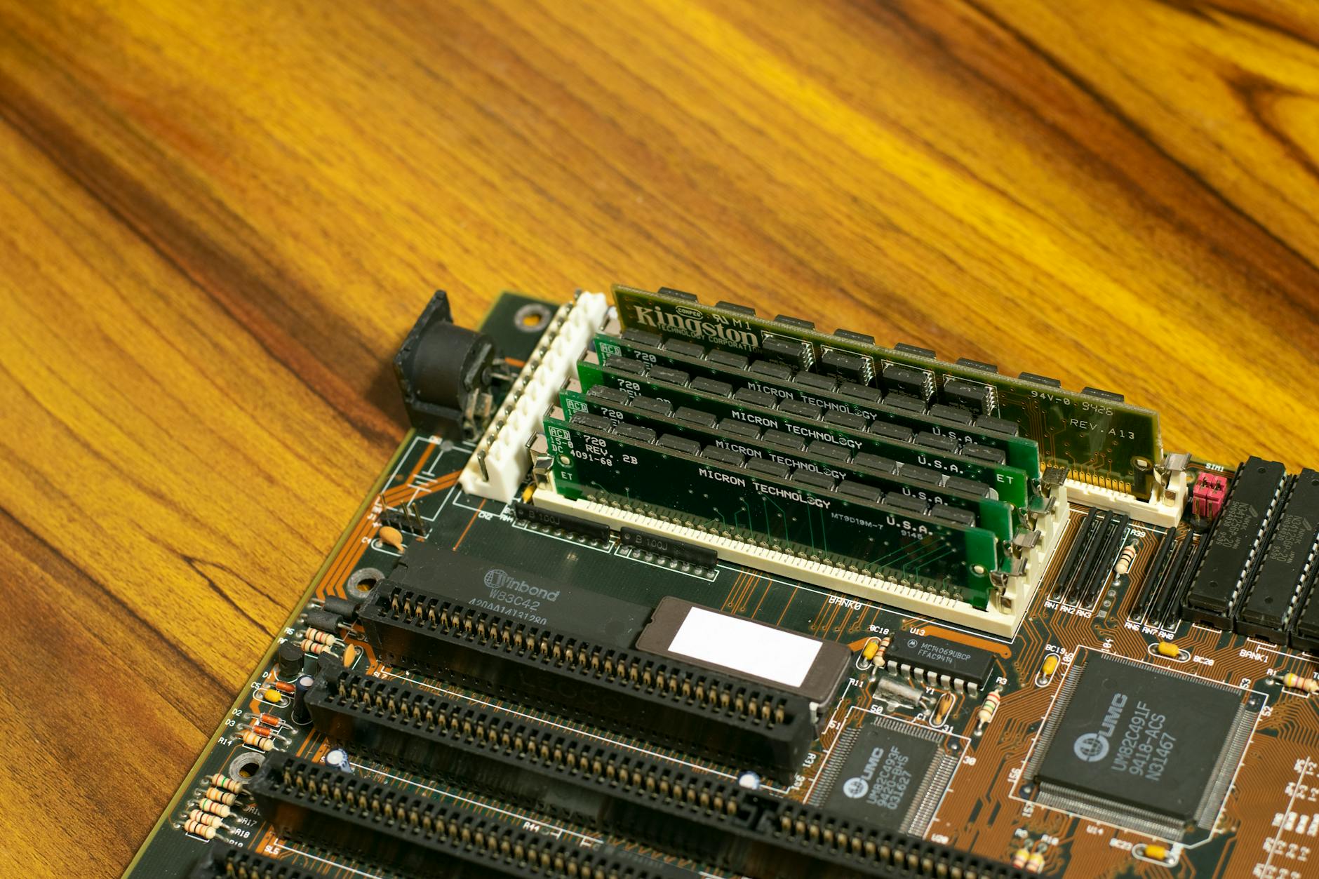 Various PC gaming components laid out including graphics card, motherboard, and RAM modules