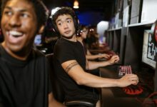 Large esports tournament arena with multiple screens and competitive gaming setup