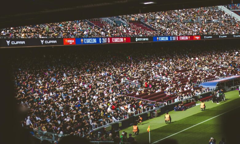 Large crowd of enthusiastic fans cheering in a modern sports stadium