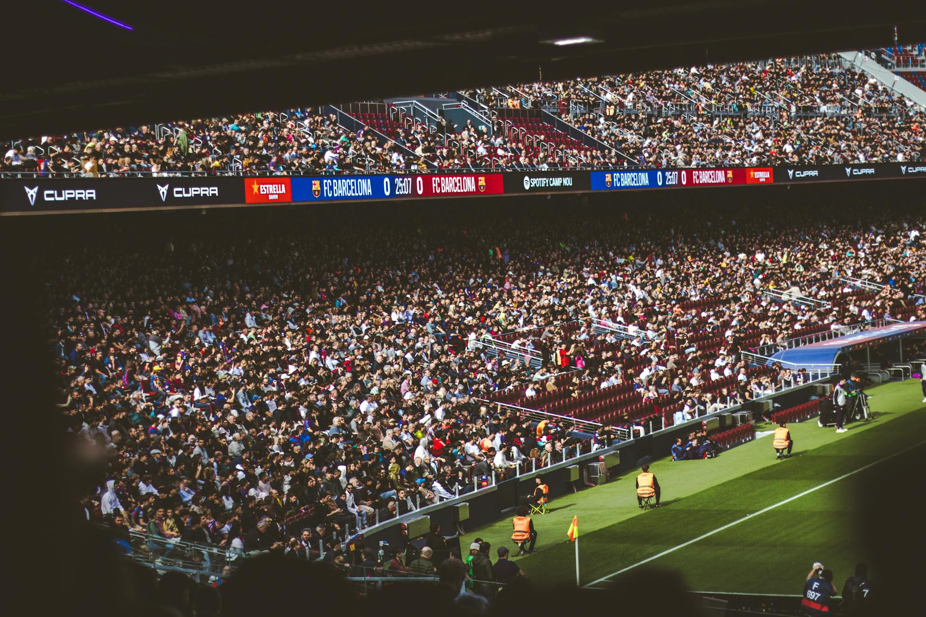 Large crowd of enthusiastic fans cheering in a modern sports stadium