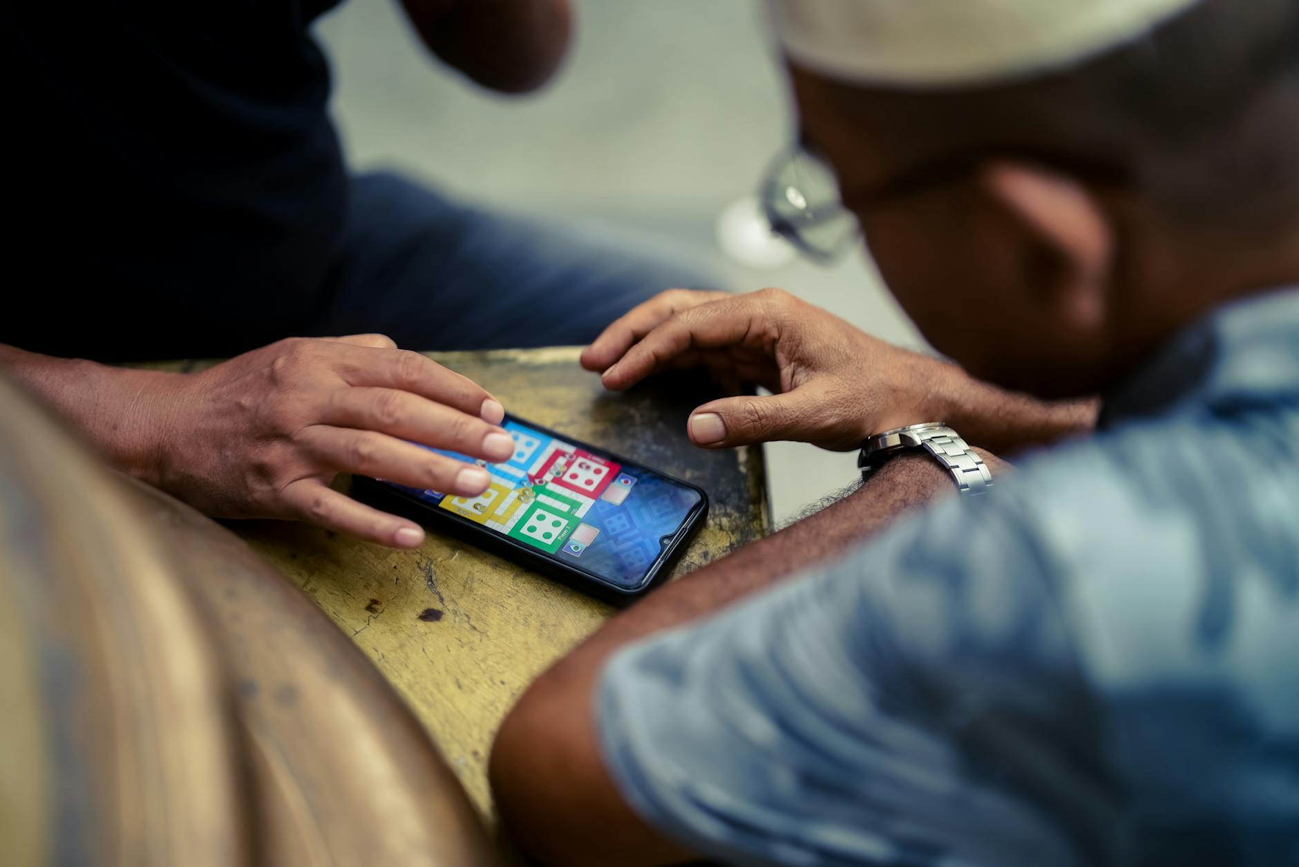 Person holding smartphone displaying mobile gaming interface