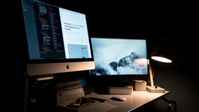 Multiple computer monitors arranged on a gaming desk setup