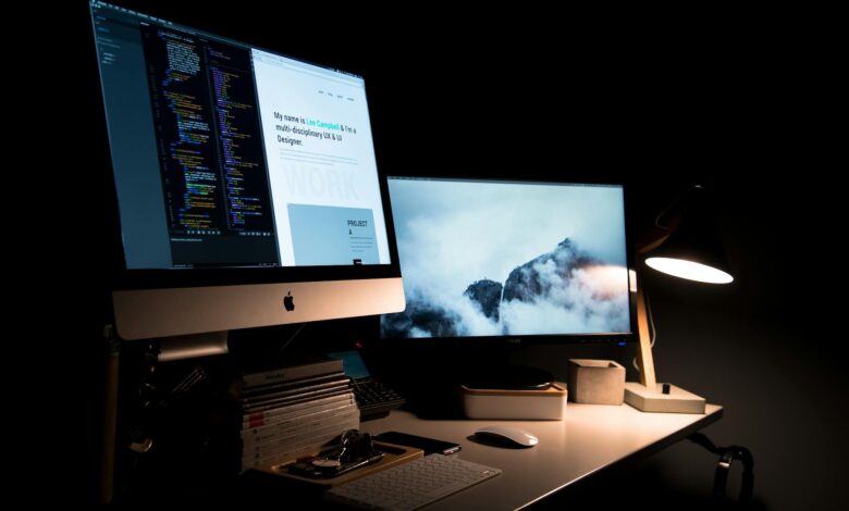 Multiple computer monitors arranged on a gaming desk setup