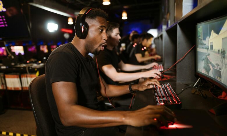 Professional esports tournament arena with gaming setups and stage lighting