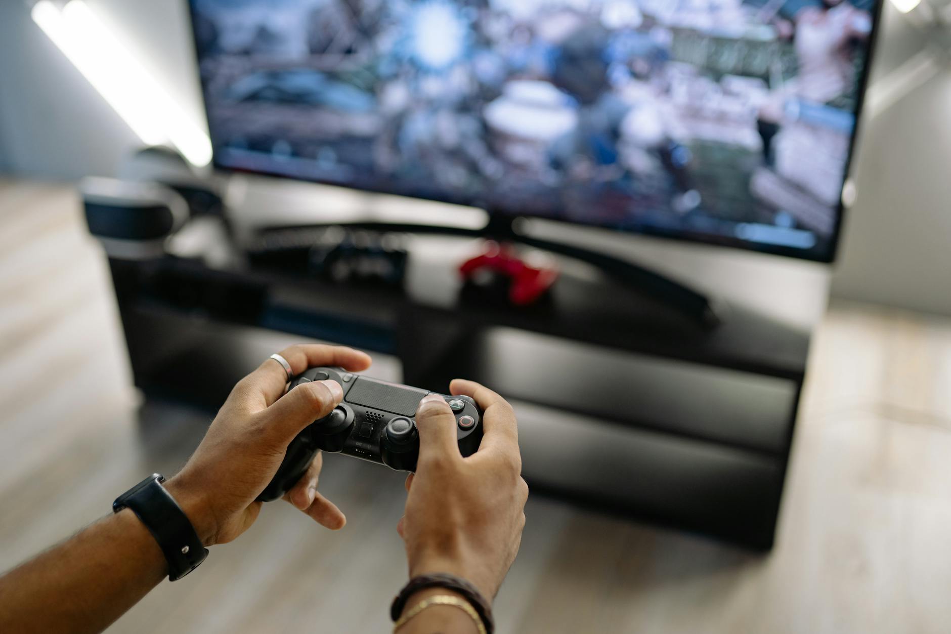 Modern gaming console on entertainment center displaying game selection interface