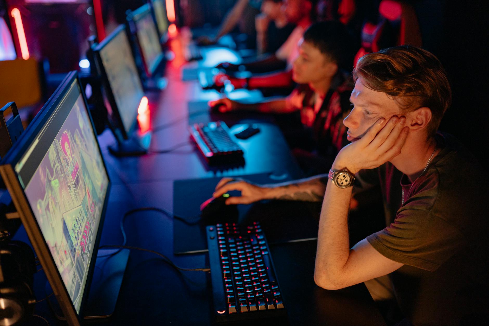 Large crowd watching esports tournament on multiple screens in arena venue