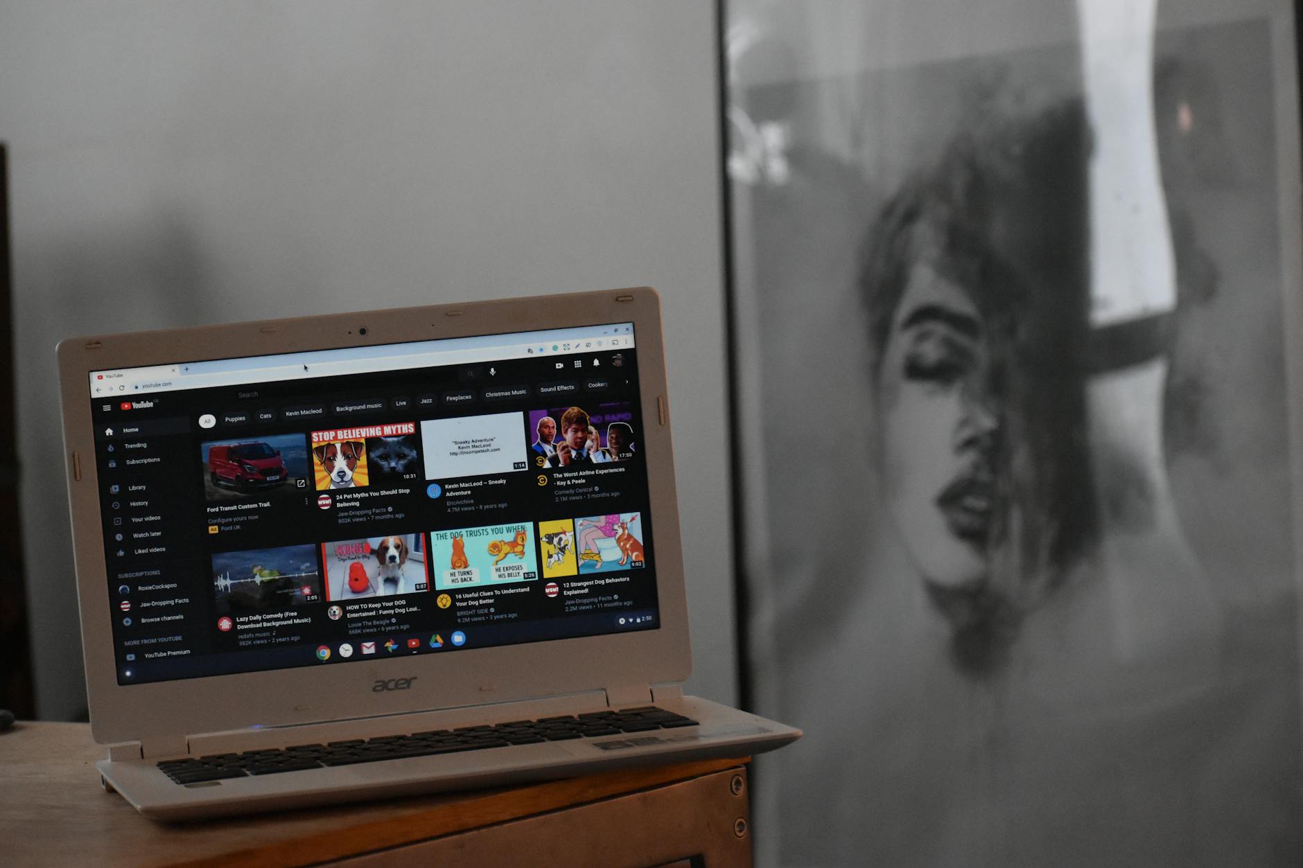 Person using laptop for live streaming with professional microphone and webcam