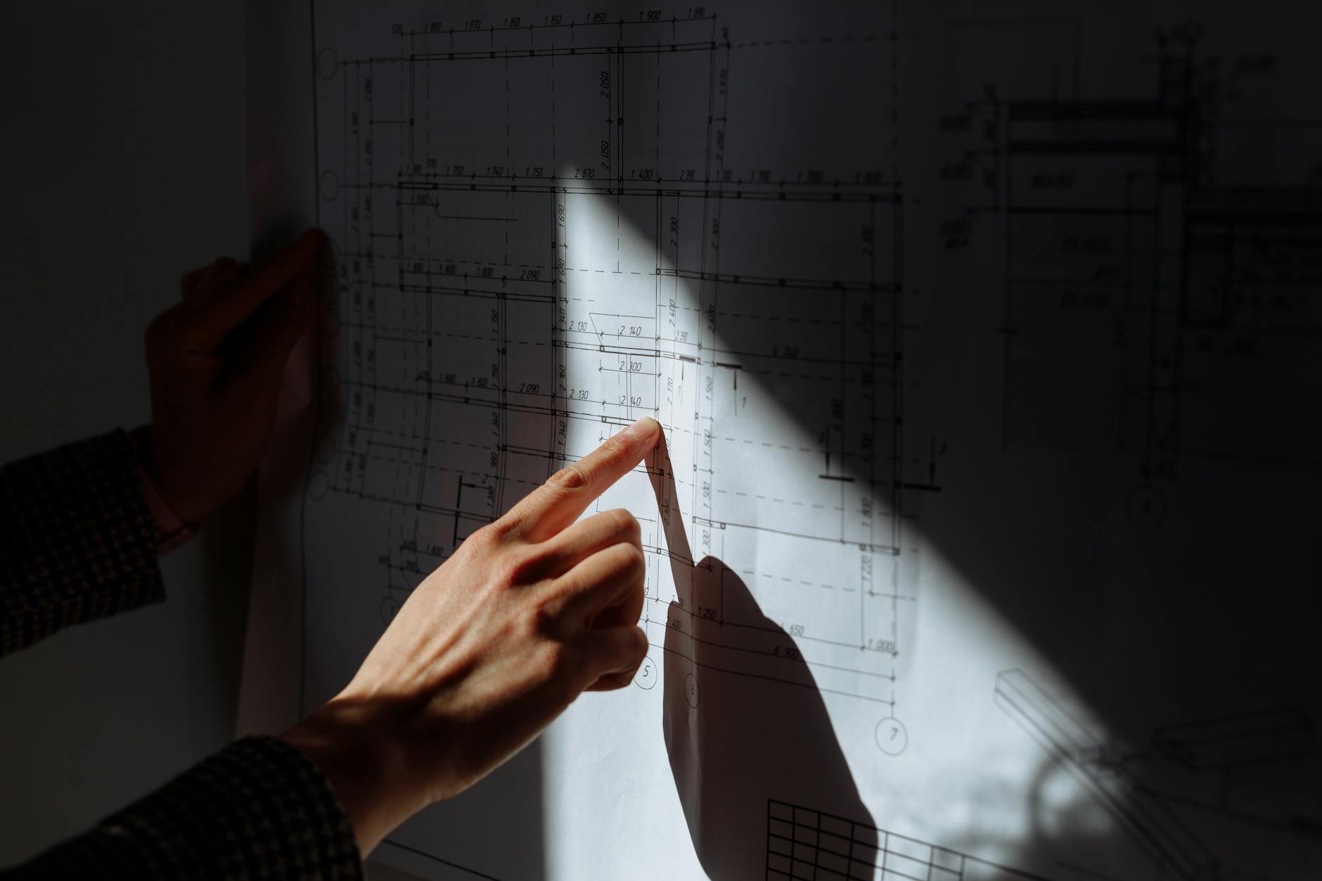 Technical engineering blueprints and design schematics on desk