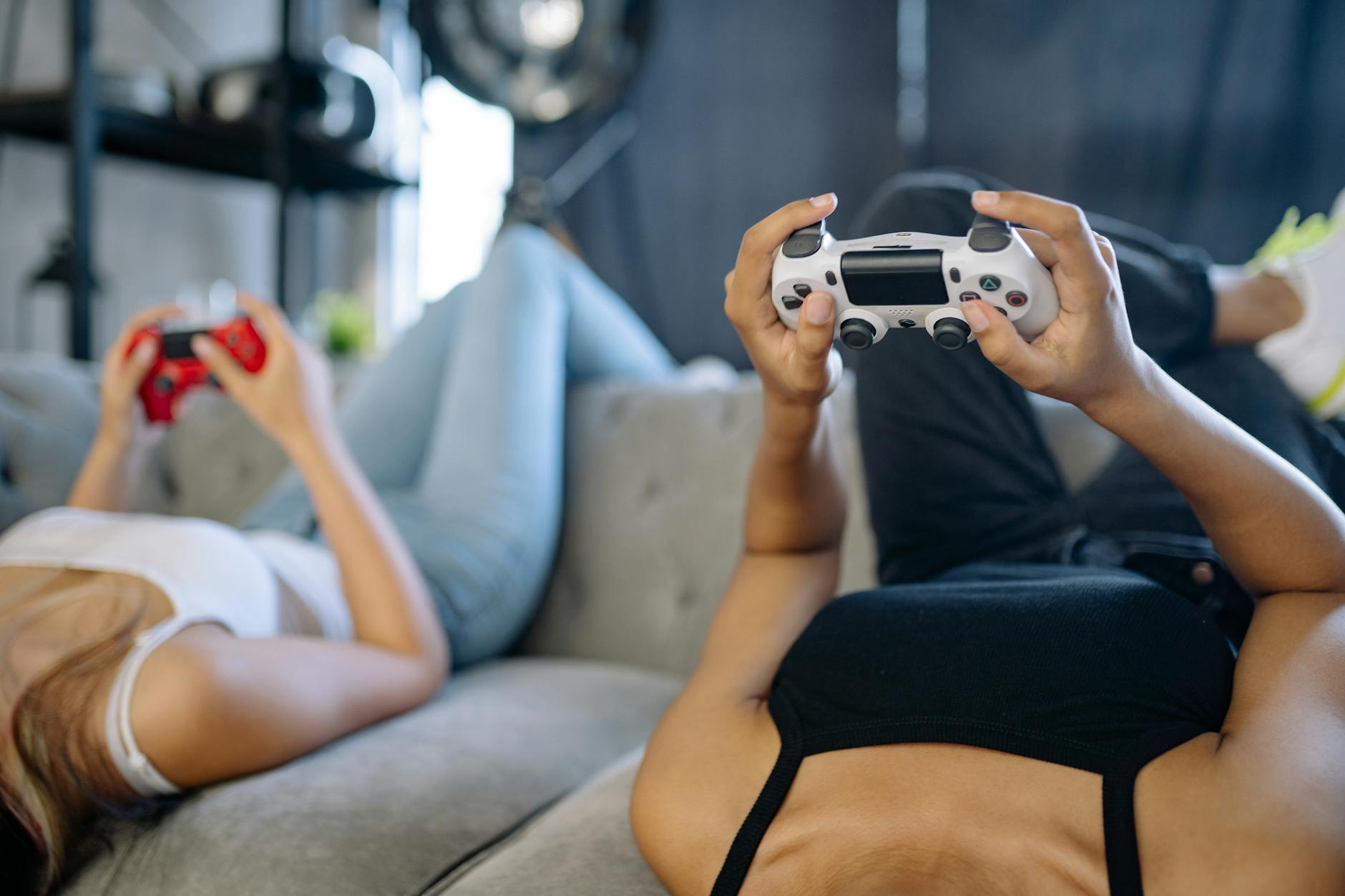 Group of friends playing video games together on different devices
