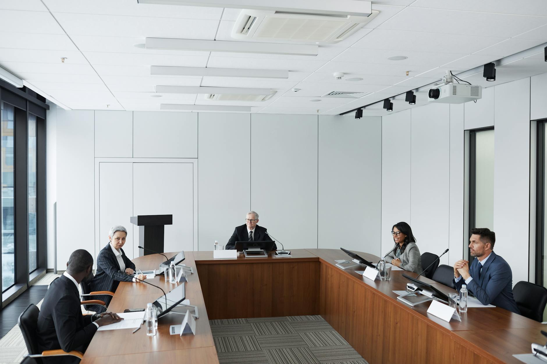 Professional business meeting with documents and laptops on conference table