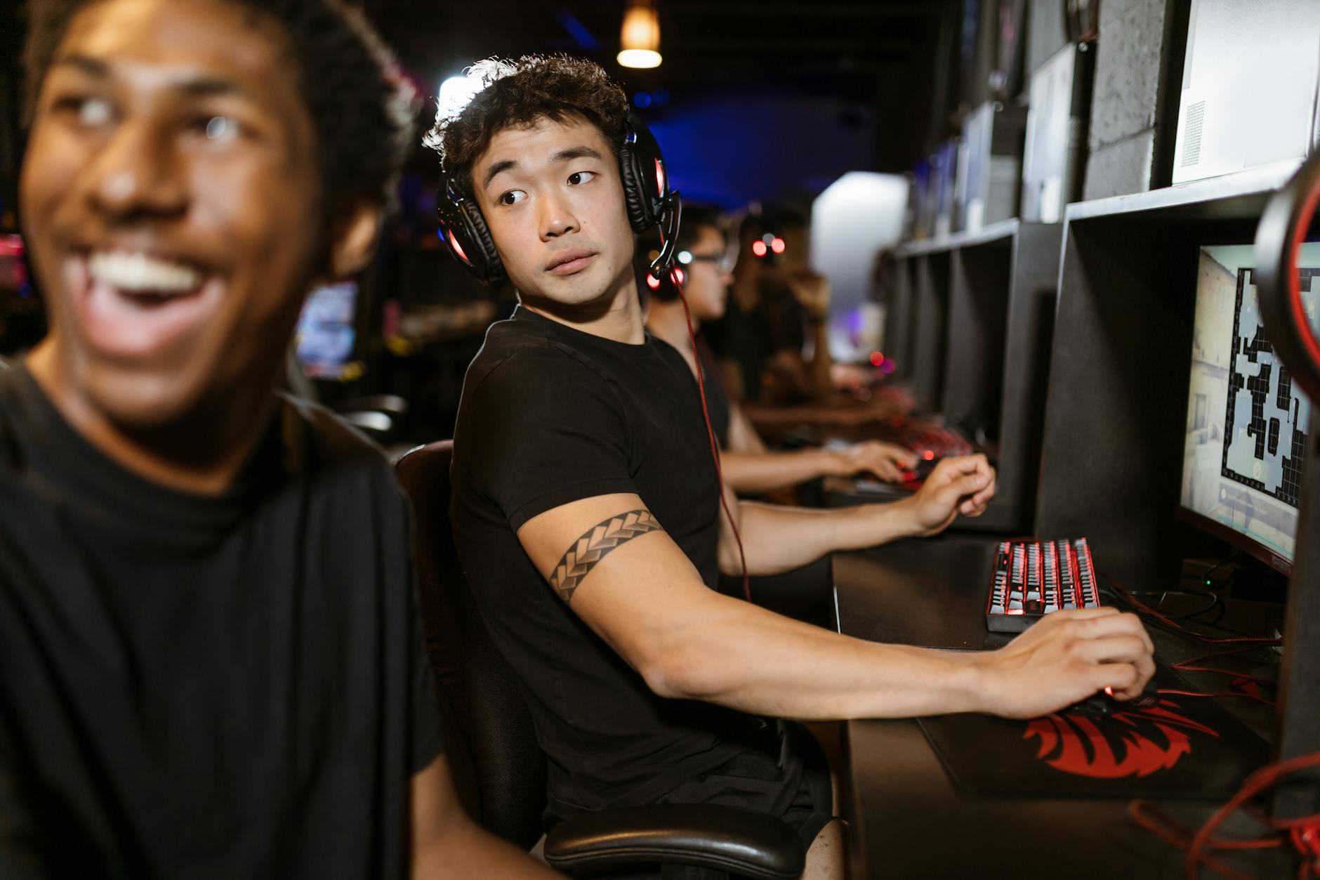 Professional esports player competing at tournament with mechanical keyboard and gaming setup