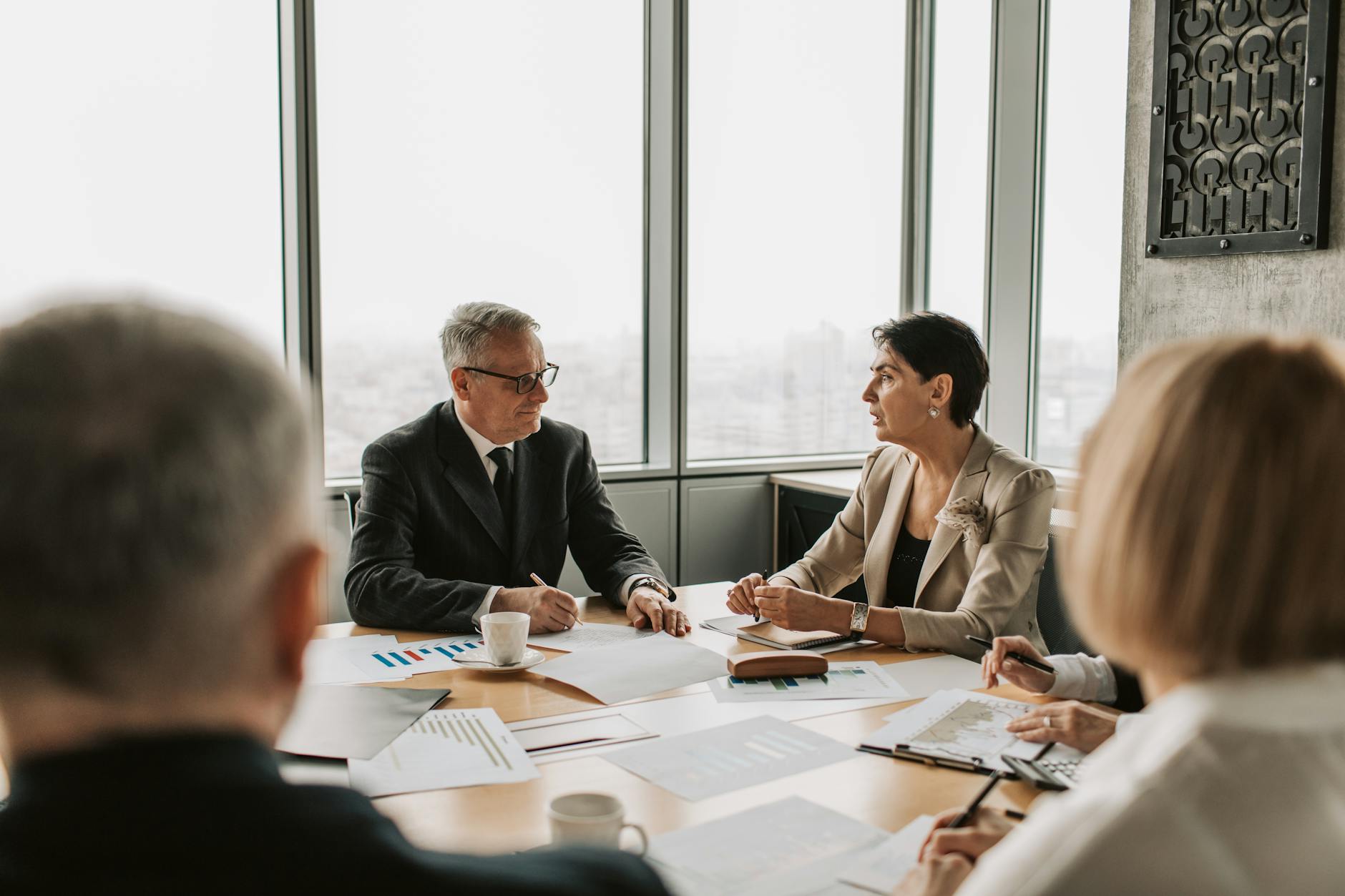 Business professionals in meeting discussing digital platform strategy and revenue models