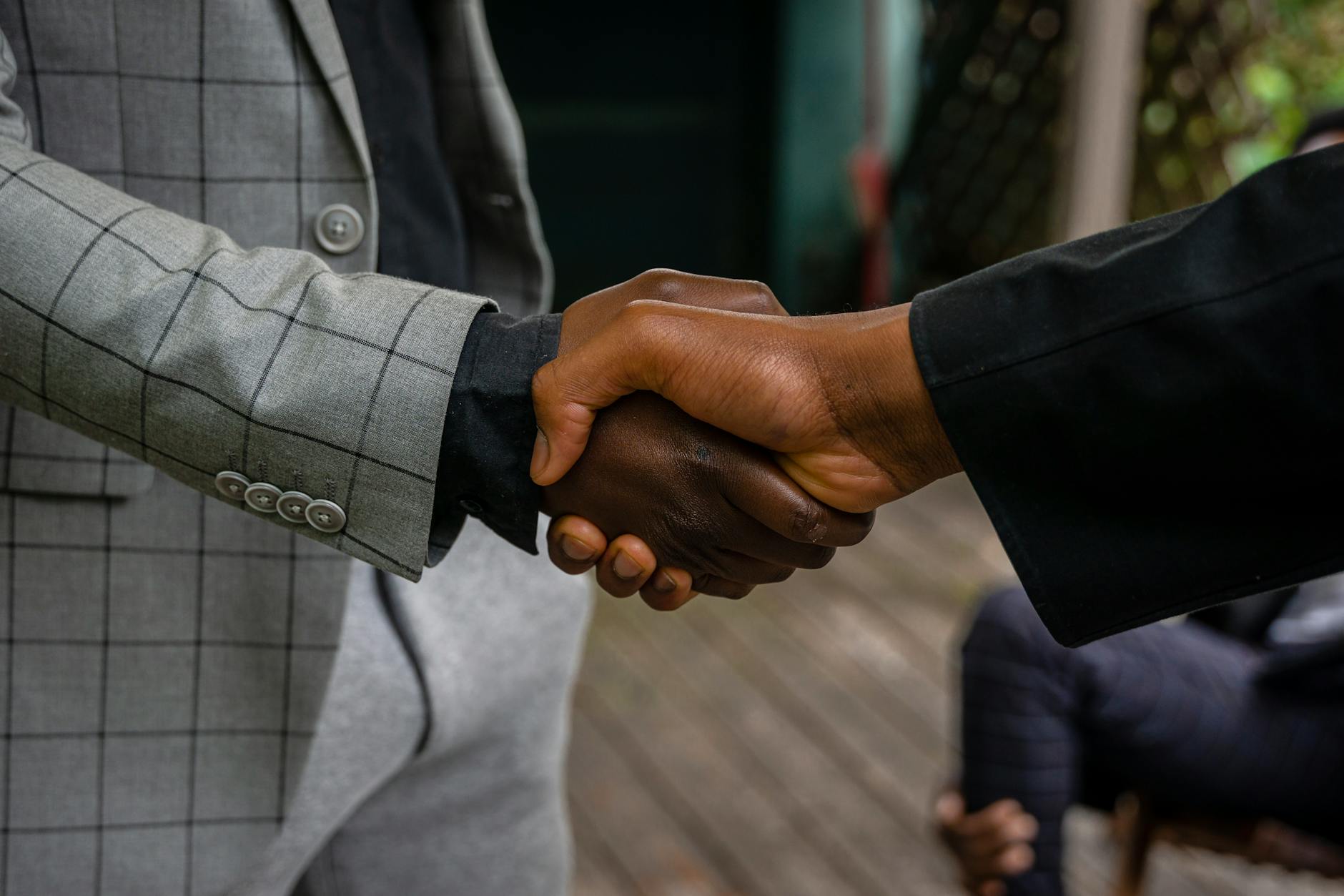 Professional business handshake representing industry partnerships and sustainable esports models