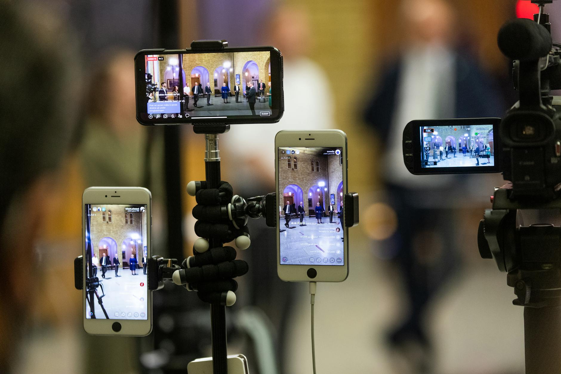 Content creator streaming mobile gameplay to online audience with professional setup