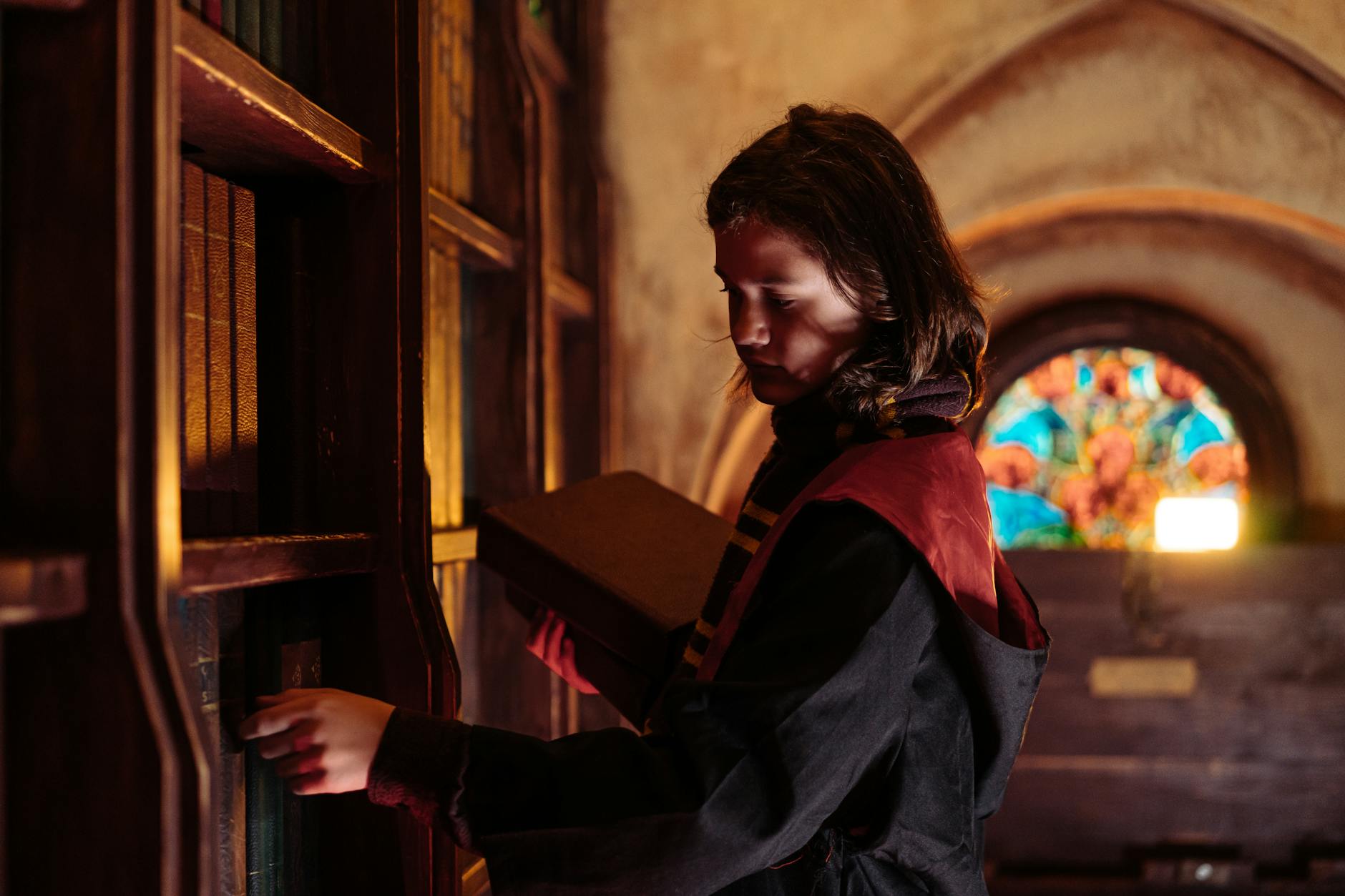 Ancient library with old books representing the magical world setting of Hogwarts Legacy