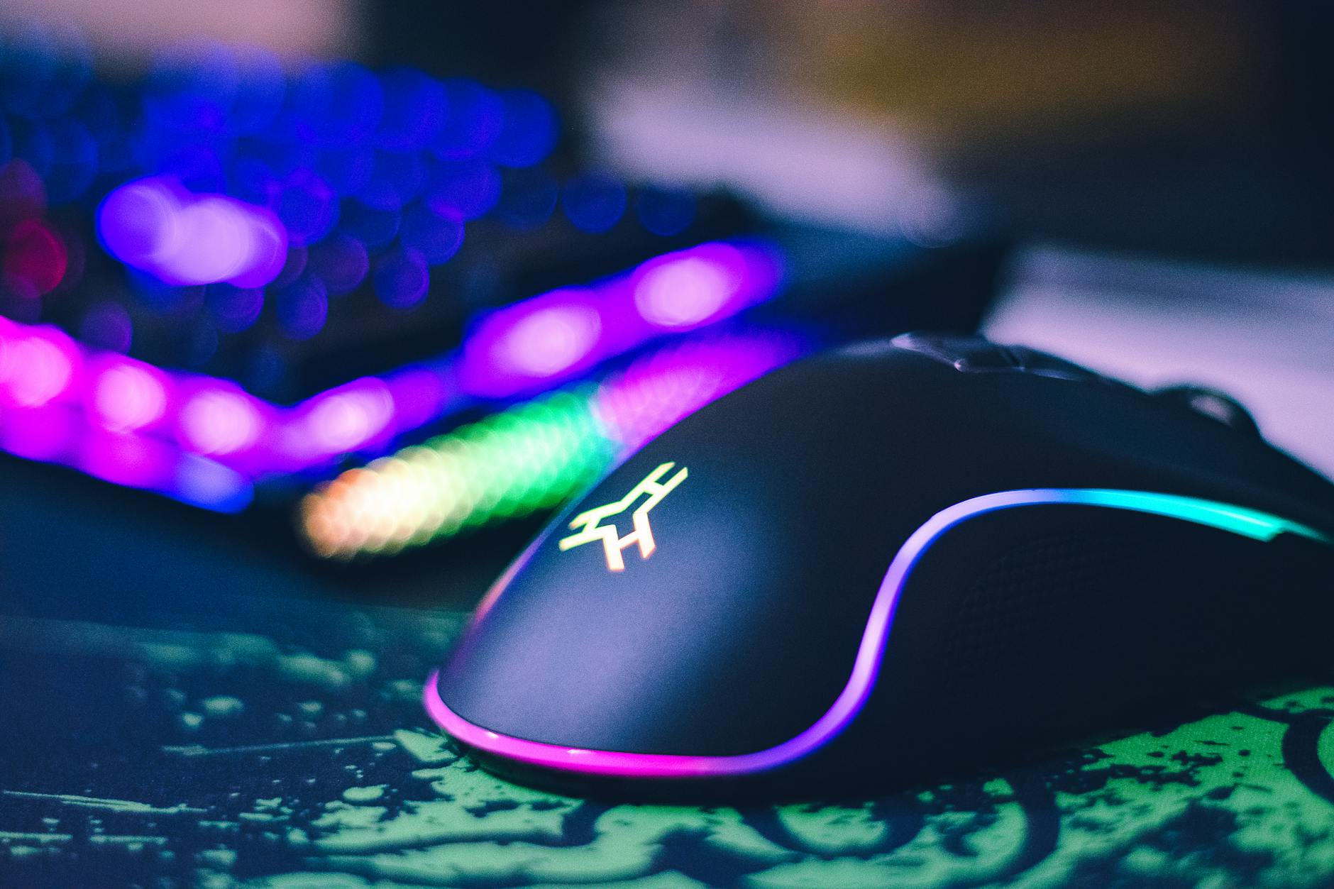 Professional gaming keyboard and mouse setup on a desk with RGB backlighting