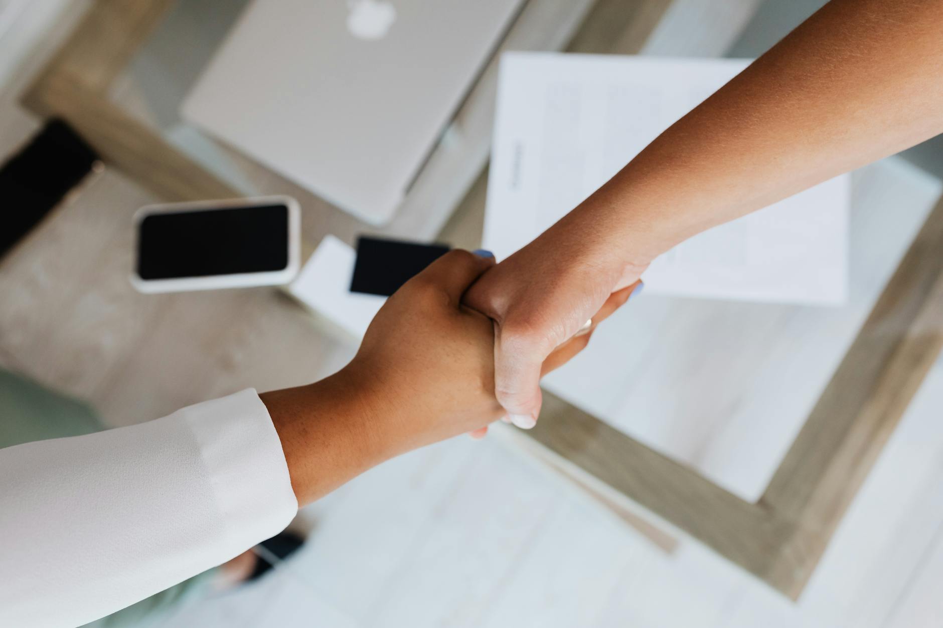 Professional handshake representing labor agreement and collective bargaining between workers and management