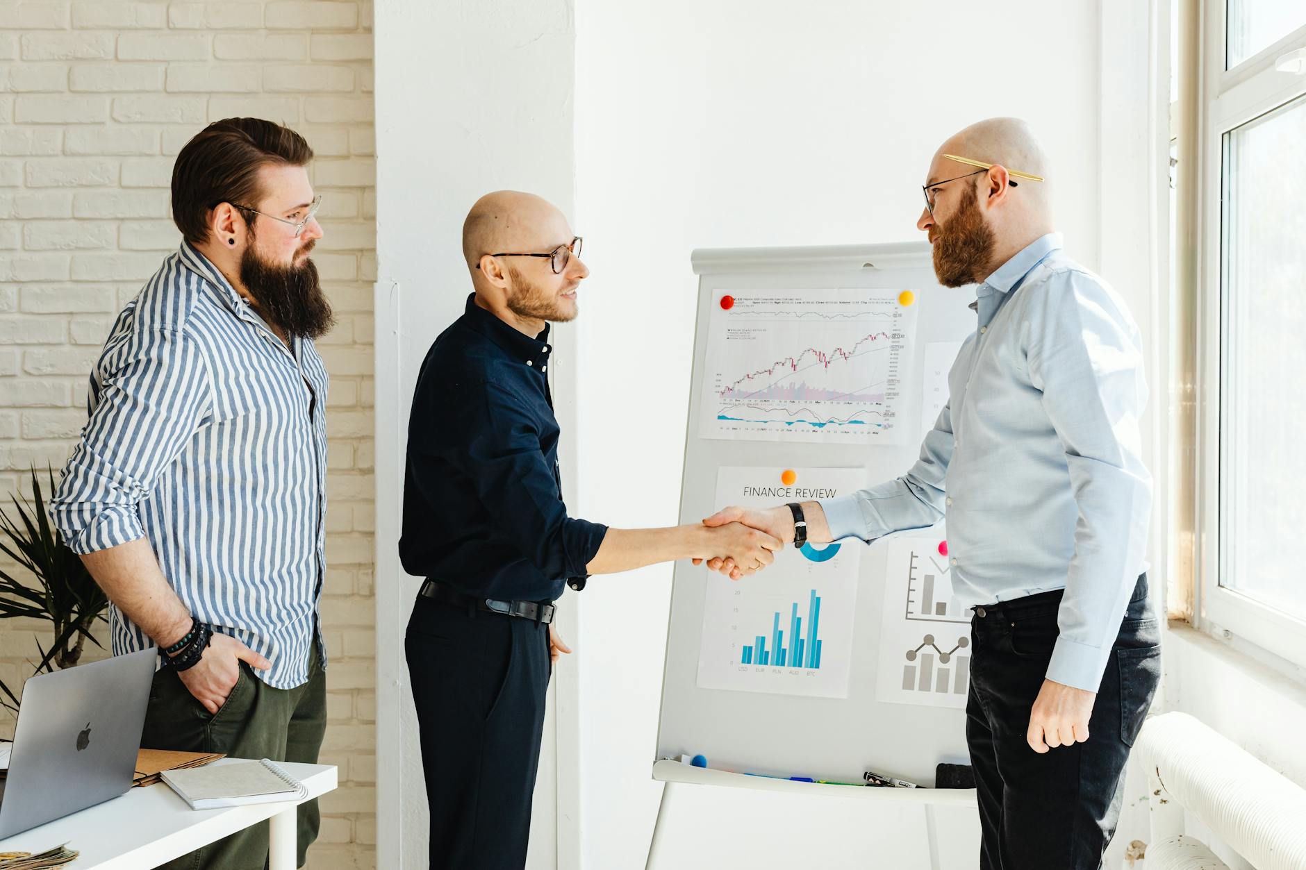 Professional business handshake between executives in modern office setting
