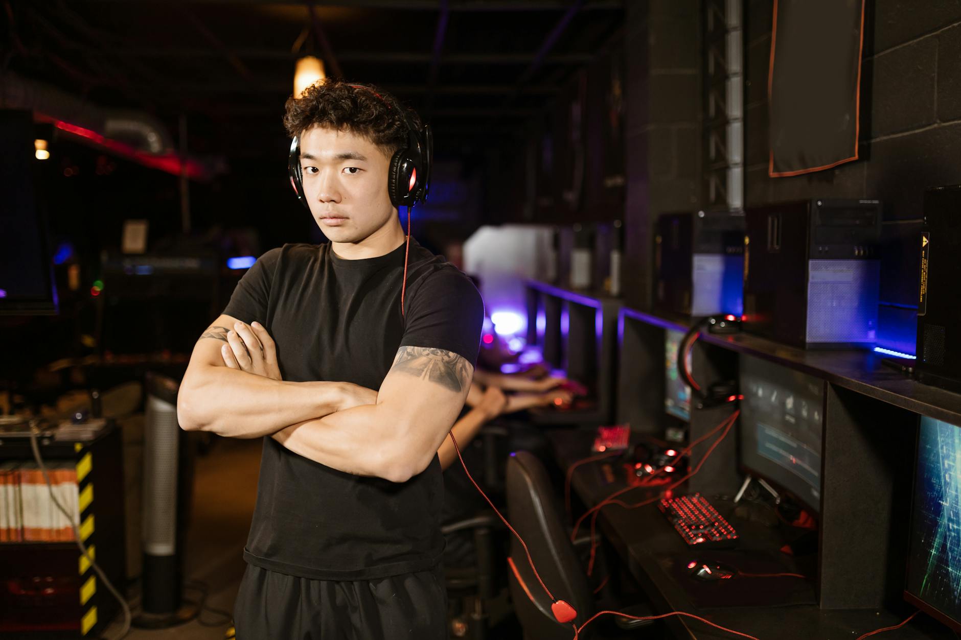 Large esports arena with crowd watching competitive gaming tournament on main stage screens