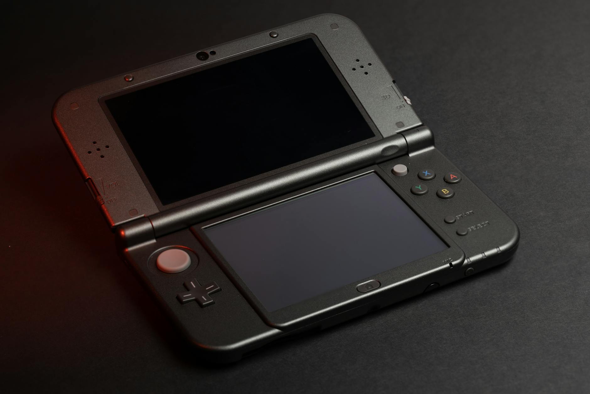 Person holding portable gaming device while relaxing on couch