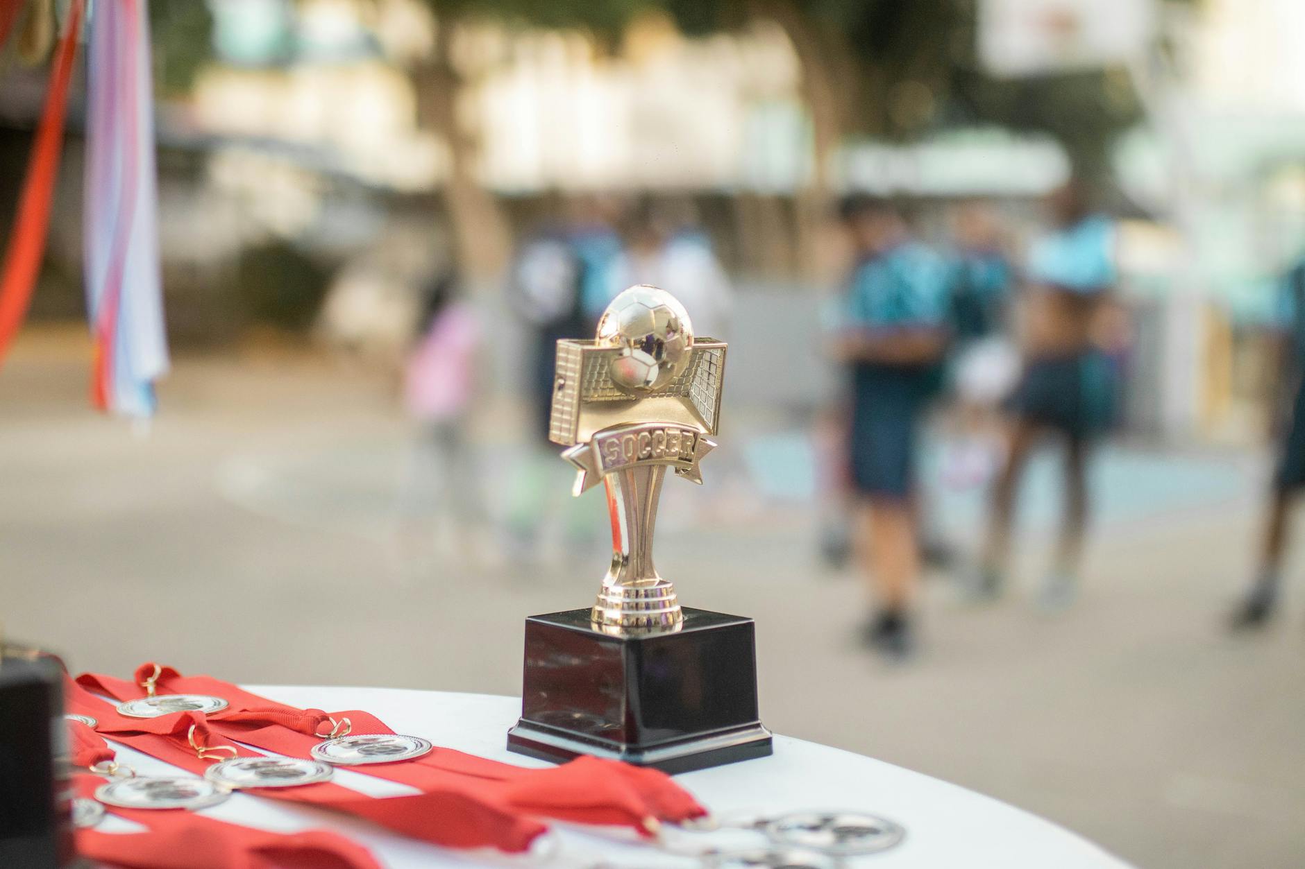 Golden trophy on podium representing esports championship victory