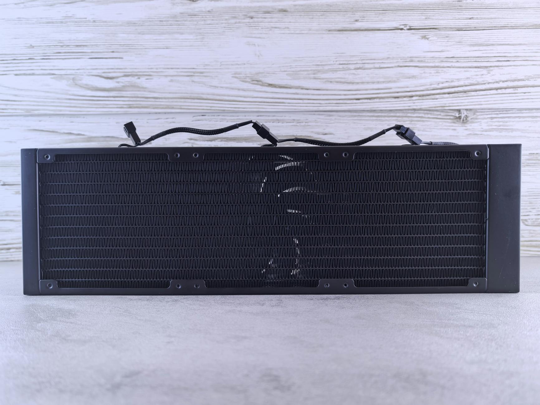 Close-up view of computer liquid cooling radiator with fans and tubing