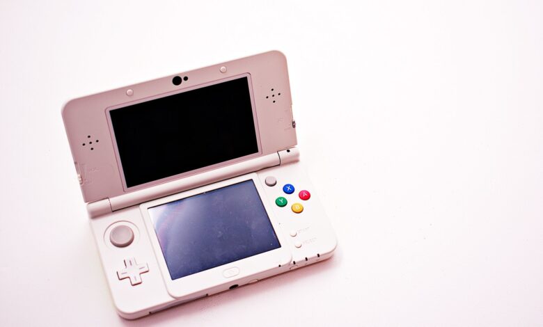 Steam Deck OLED handheld gaming device held in hands against a neutral background