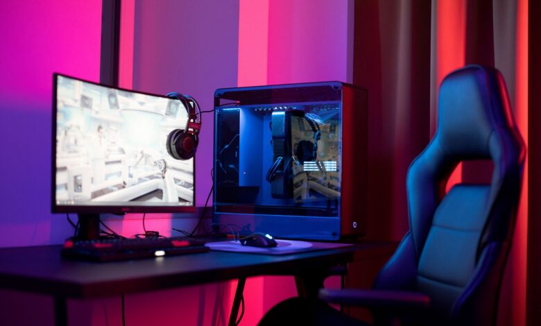 A high-performance gaming PC setup with RGB lighting and dual monitors