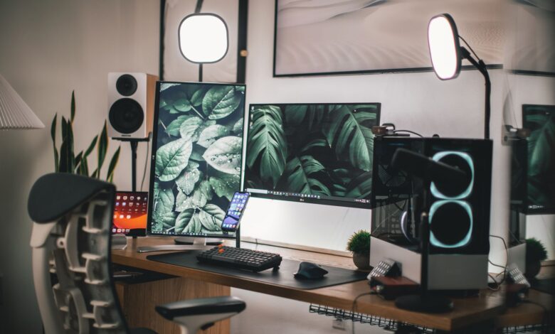 Gaming monitor on a desk showing a bright display in a darkened room