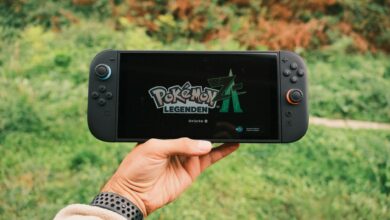 A handheld gaming PC device held in two hands during gameplay