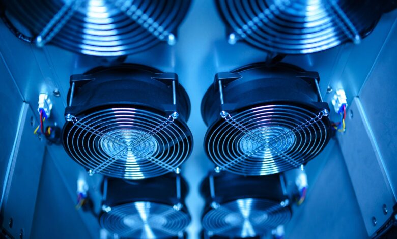 Close-up of a CPU cooler mounted on a motherboard with thermal paste visible on the processor IHS