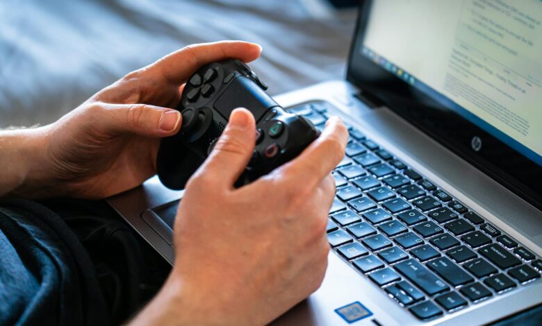 High-end gaming laptop open on a desk displaying a graphics-intensive game