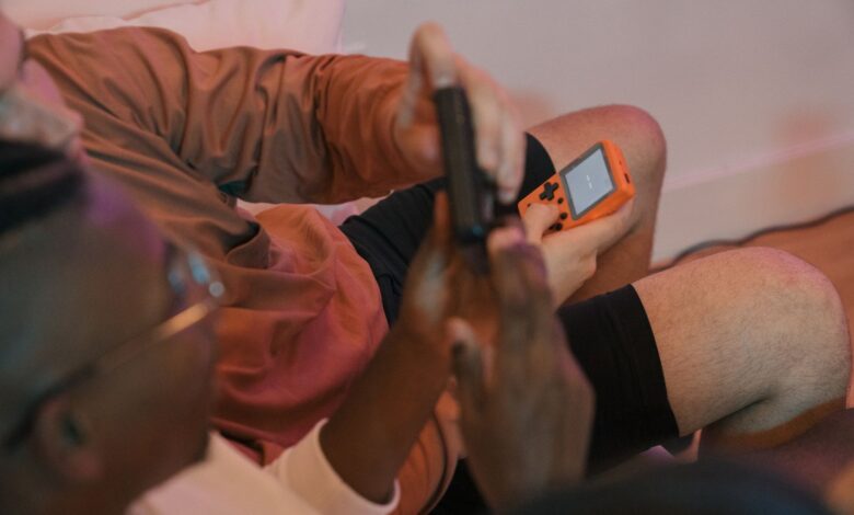 Person holding a handheld PC gaming device while playing a game